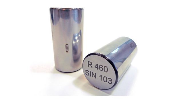 Cylindrical rollers with linear laser burns, on a white background